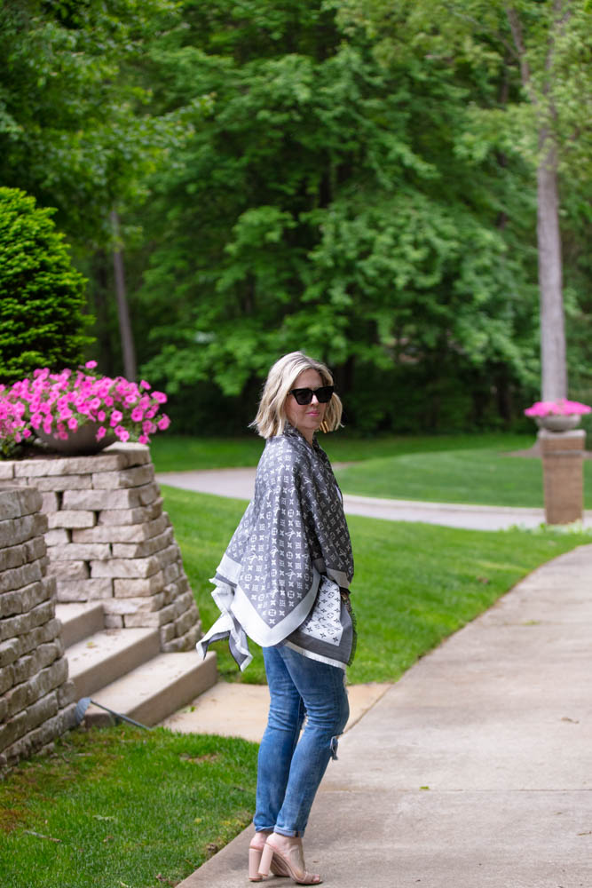 How to Afford Luxury Items when shopping in Italy featured by top US life and style blogger, Dawned on Me: image of a woman wearing a Louis Vuitton Monogrammed Shawl