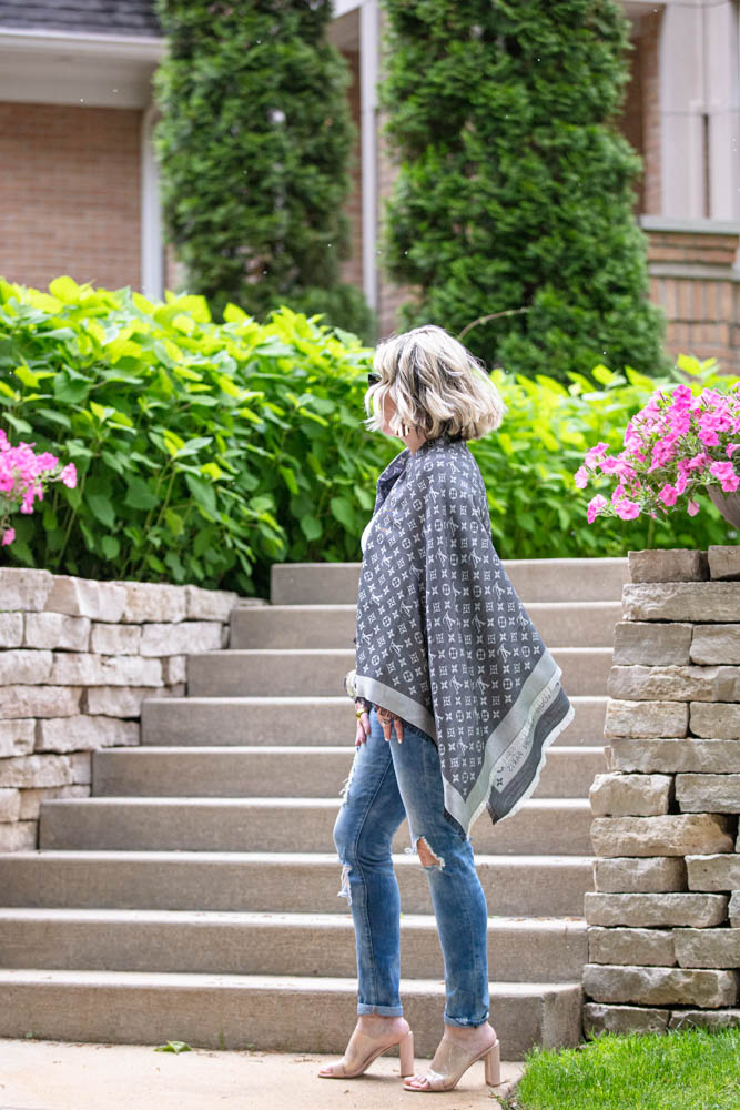 How to Afford Luxury Items when shopping in Italy featured by top US life and style blogger, Dawned on Me: image of a woman wearing a Louis Vuitton Monogrammed Shawl